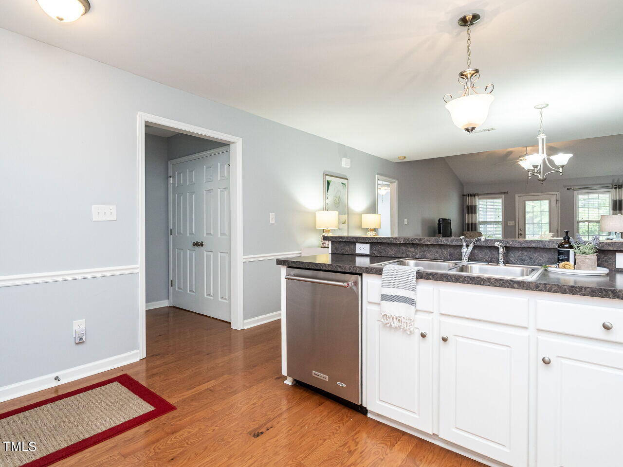 585 Pinecroft Drive Clayton, NC 27520 - Photo 6 of 26 a kitchen with kitchen island a sink a stove a dining table and chairs