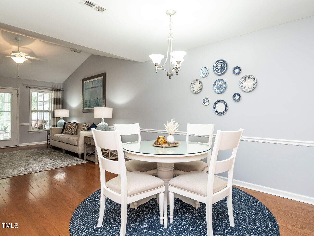 585 Pinecroft Drive Clayton, NC 27520 - Photo 7 of 26 a dining room with furniture a chandelier and wooden floor