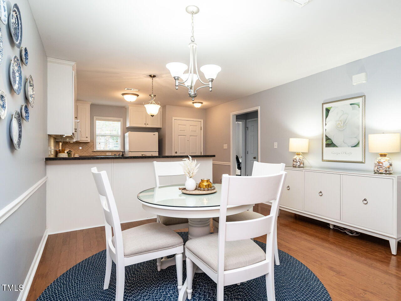585 Pinecroft Drive Clayton, NC 27520 - Photo 8 of 26 a view of a dining room with furniture and wooden floor