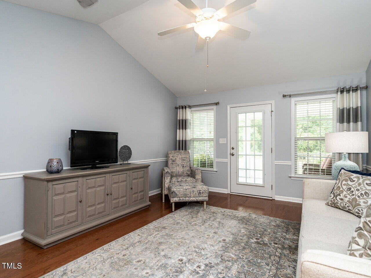 585 Pinecroft Drive Clayton, NC 27520 - Photo 9 of 26 a living room with furniture and a flat screen tv