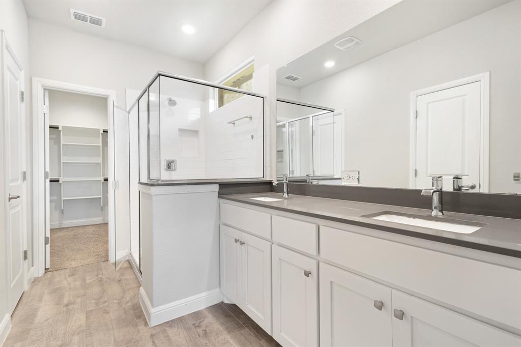 820 Wilmott Terrace Justin, TX 76247 - Photo 11 of 22 a bathroom with a double vanity sink and mirror