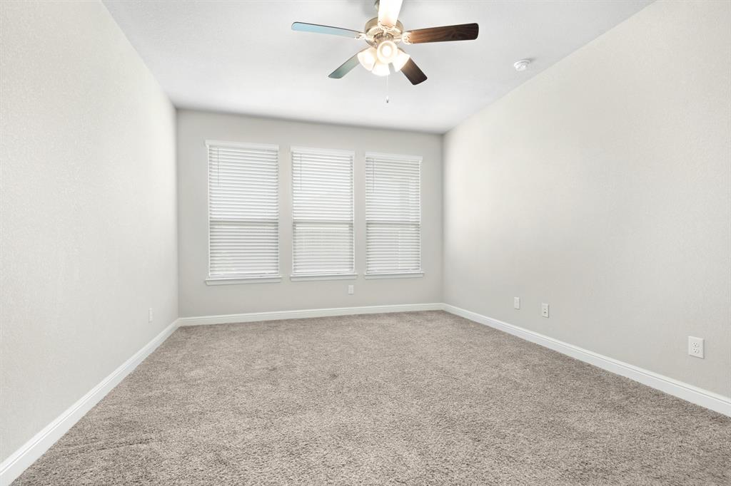 820 Wilmott Terrace Justin, TX 76247 - Photo 12 of 22 an empty room with windows and fan
