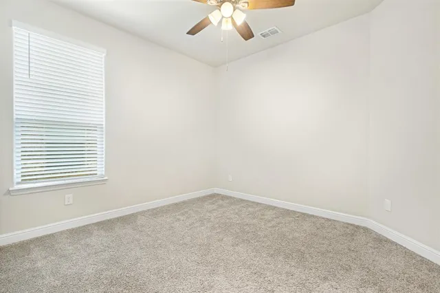 a bathroom with a granite countertop sink a toilet and bathtub