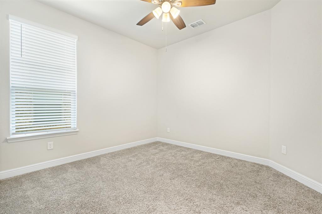 820 Wilmott Terrace Justin, TX 76247 - Photo 13 of 22 an empty room with a chandelier fan
