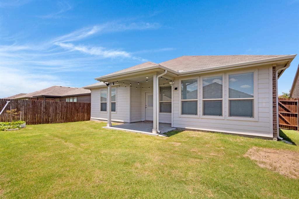 820 Wilmott Terrace Justin, TX 76247 - Photo 16 of 22 a view of a house with a backyard
