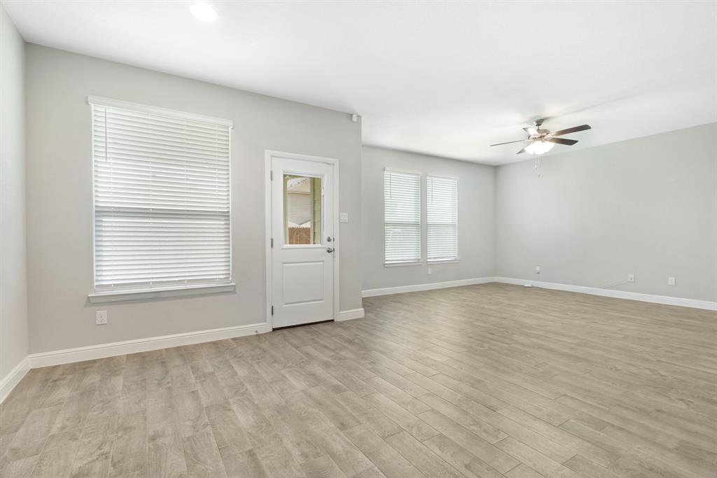 820 Wilmott Terrace Justin, TX 76247 - Photo 9 of 22 wooden floor in an empty room with a window