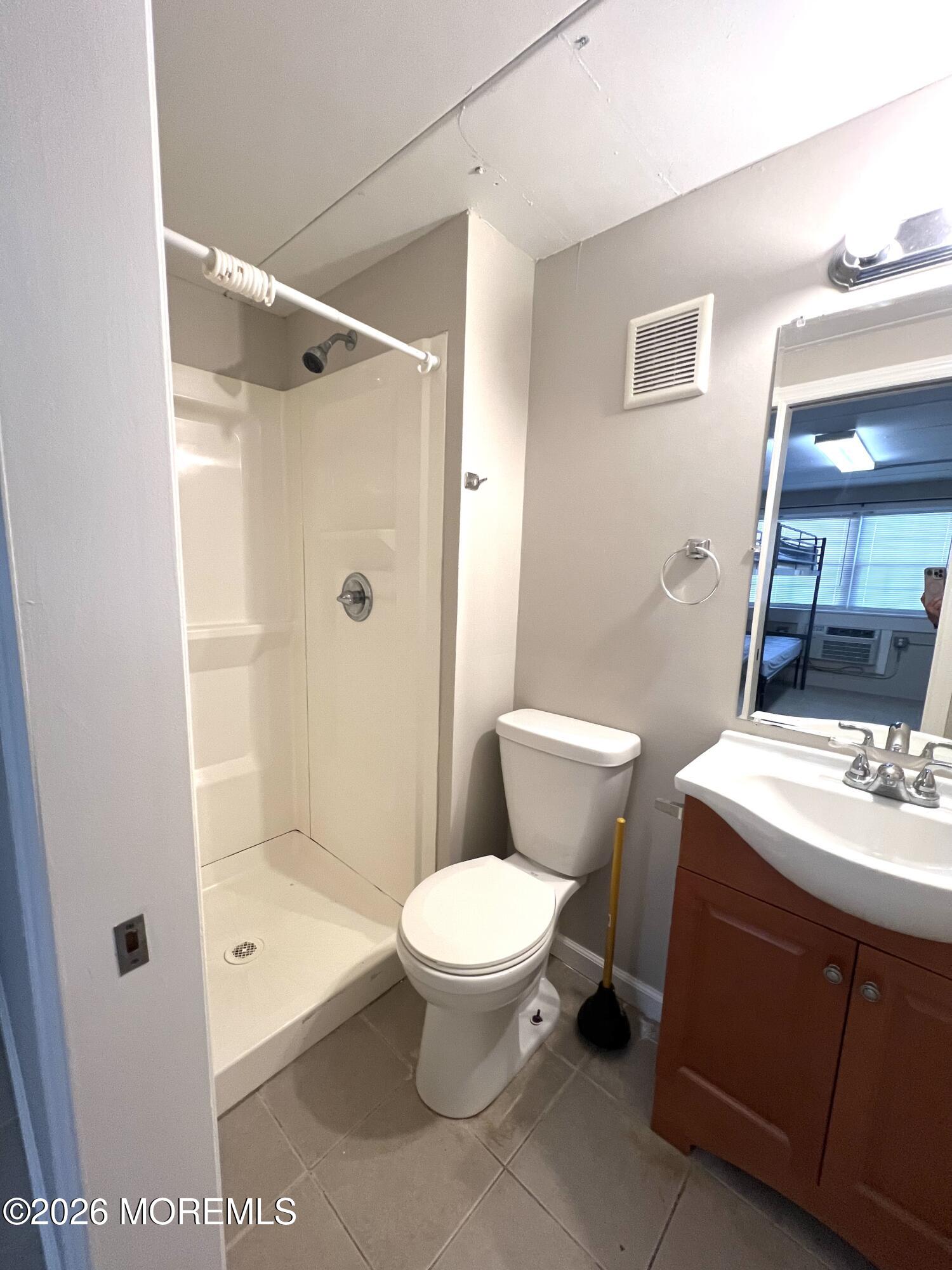 Ocean Terrace Seaside Heights, NJ 08751 - Photo 13 of 25 a bathroom with a granite countertop sink toilet and shower