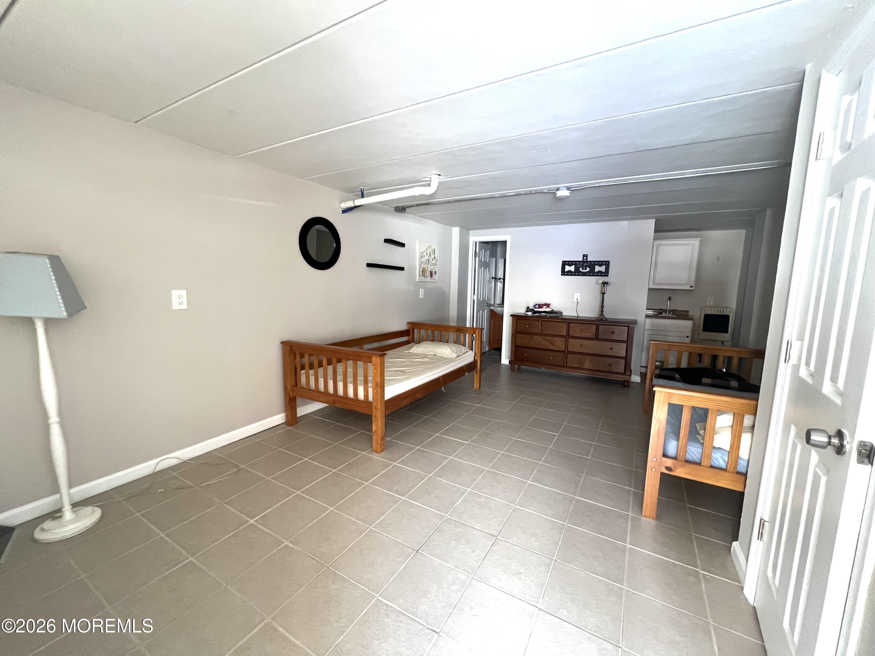 Ocean Terrace Seaside Heights, NJ 08751 - Photo 19 of 25 a bedroom with furniture and a window