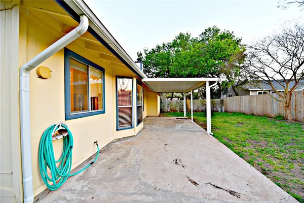 a view of an house with backyard and sitting area