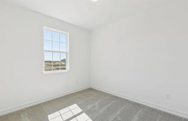 an empty room with a empty space and window