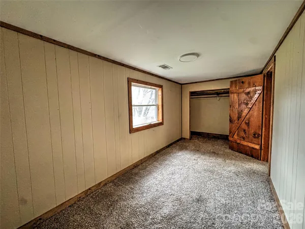 a view of an empty room and stairs