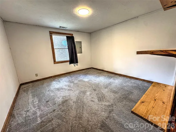 an empty room with a empty space and windows