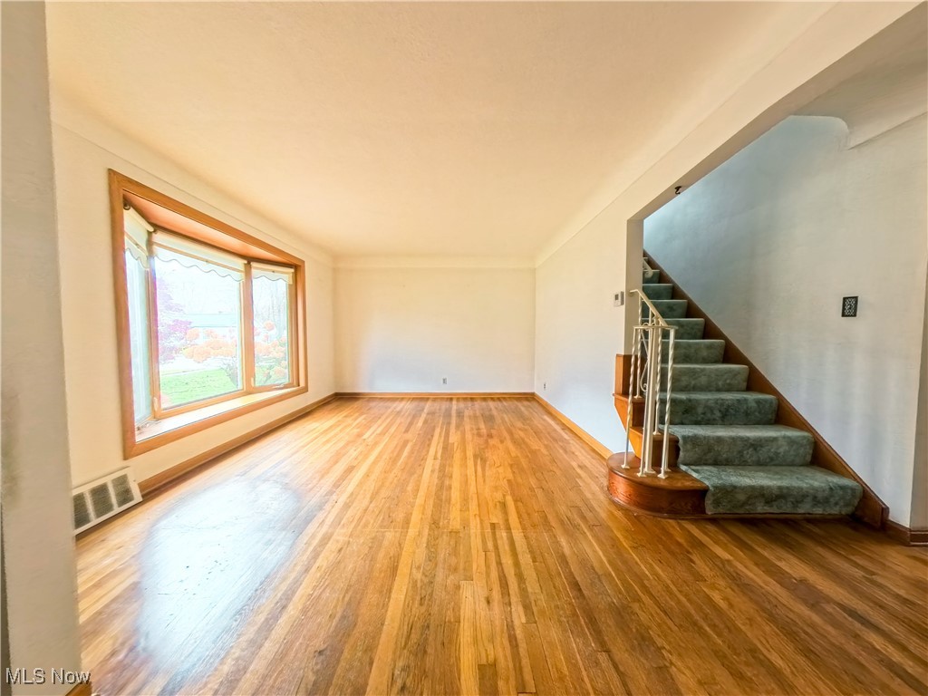 1668 Harwich Road Cleveland, OH 44124 - Photo 2 of 19 Unfurnished living room with hardwood / wood-style floors and stairs