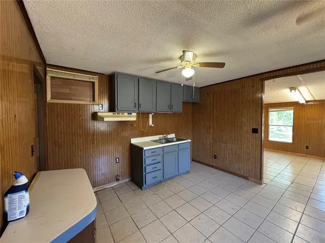 a kitchen with a refrigerator and a sink