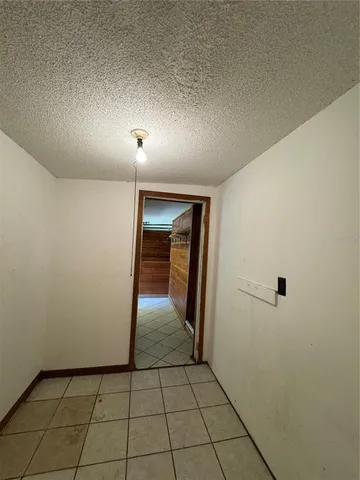 an empty room with mirror and entrance