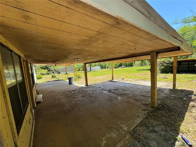 a view of a room with wooden floor and a table