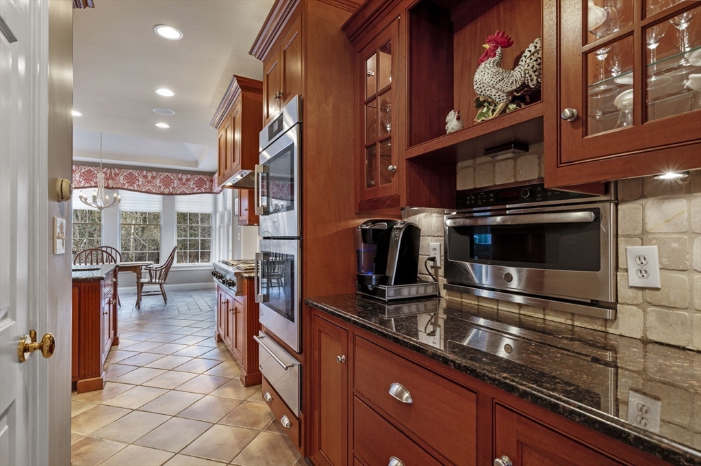 8 Azalea Way Boxford, MA 01921 - Photo 16 of 42 a kitchen with stainless steel appliances a stove and a refrigerator
