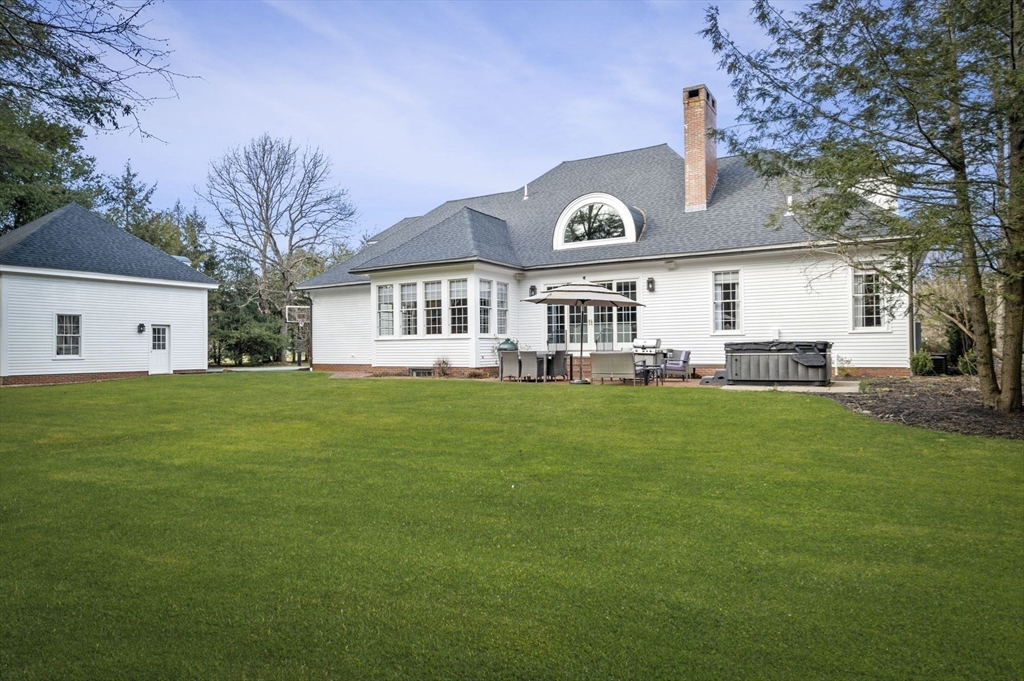 8 Azalea Way Boxford, MA 01921 - Photo 2 of 42 a front view of a house with a garden and yard