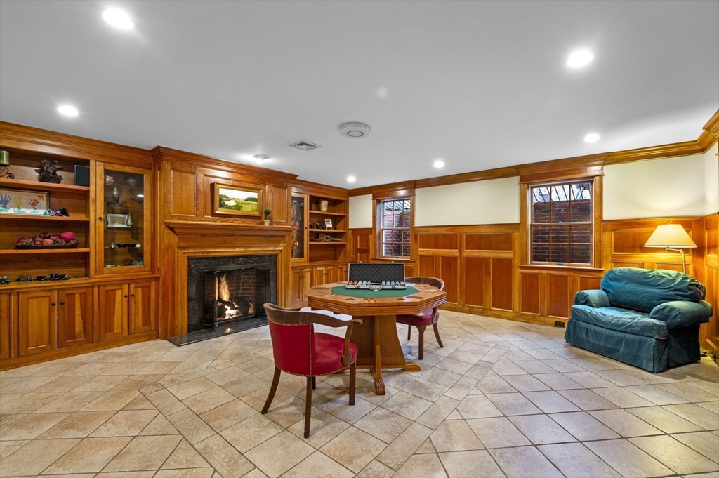 8 Azalea Way Boxford, MA 01921 - Photo 37 of 42 a living room with furniture a fireplace and a flat screen tv