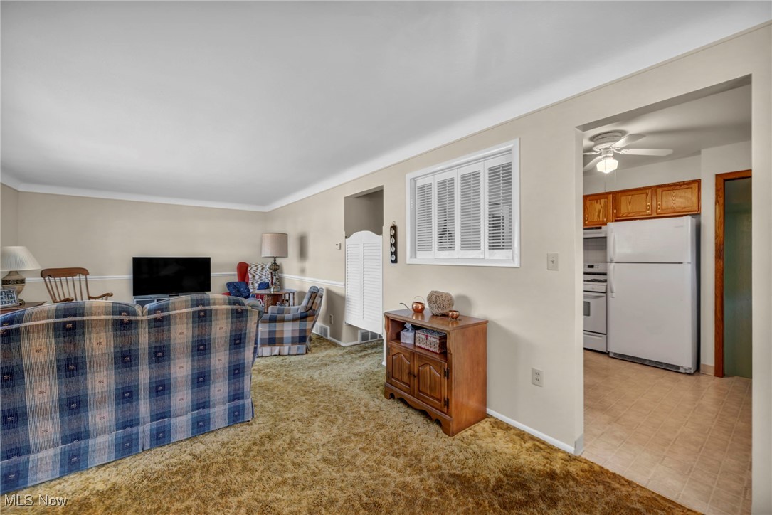 13732 Carpenter Road Garfield Heights, OH 44125 - Photo 12 of 46 Living area with light colored carpet and a ceiling fan