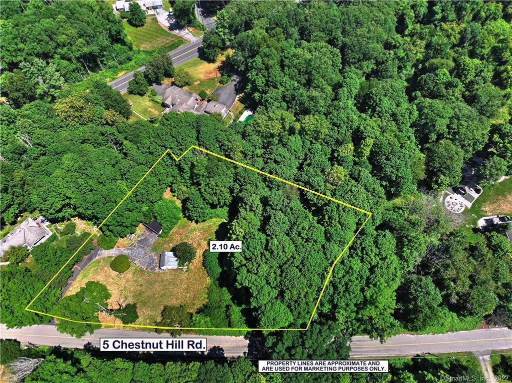 an aerial view of a house with a yard and lake view