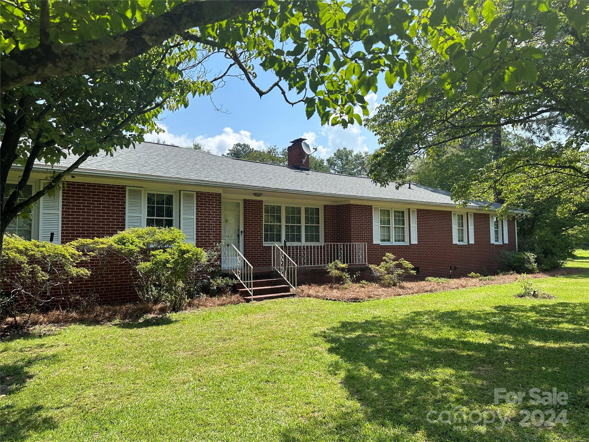 3048 Timrod Road Bethune, SC 29009 - Photo 1 of 1 a front view of house with yard and outdoor seating