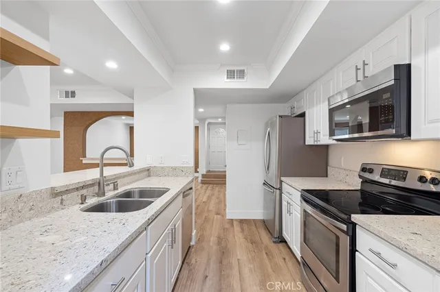 a kitchen with sink a microwave and stove