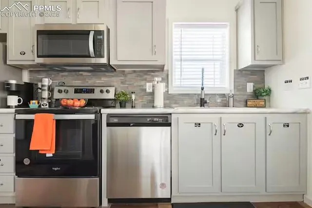 a kitchen with stainless steel appliances granite countertop a refrigerator sink and microwave