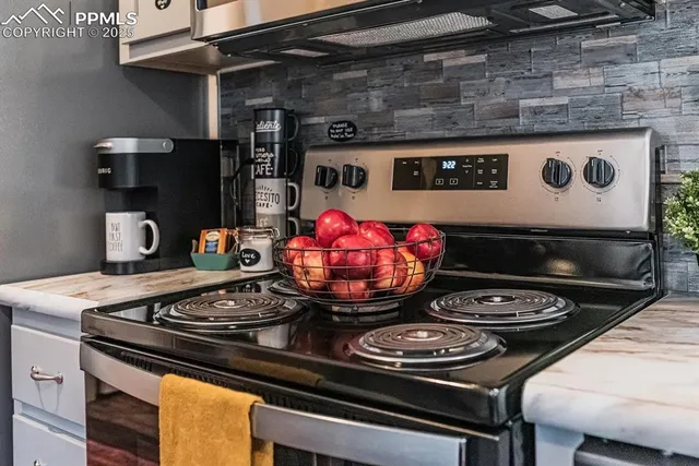a stove top oven sitting inside of a kitchen with granite countertop a stove top oven