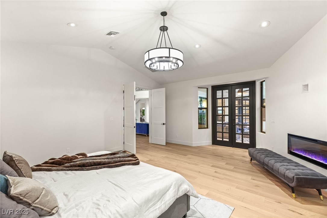 2316 Prometheus Court Henderson, NV 89074 - Photo 27 of 92 Bedroom featuring visible vents, lofted ceiling, light wood finished floors, baseboards, and a notable chandelier