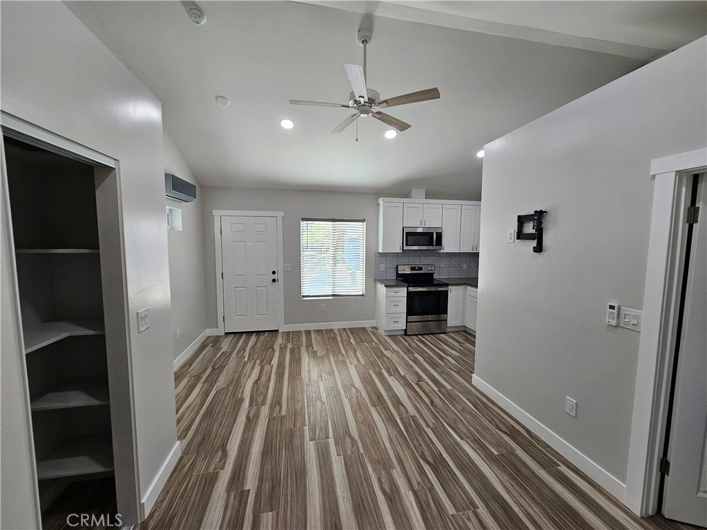 6570 Mt Diablo Avenue Riverside, CA 92506 - Photo 11 of 15 wooden floor in an empty room with a kitchen