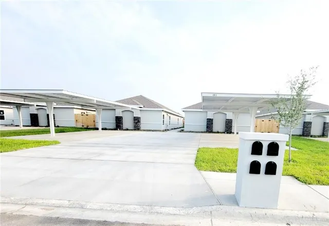 a house with tall trees in front of it