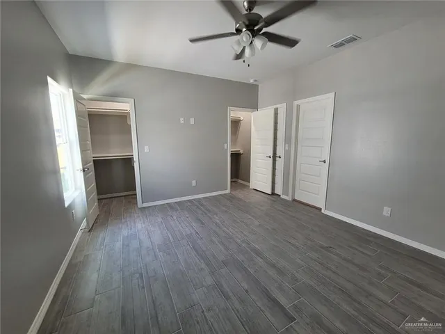 a view of hallway with wooden floor