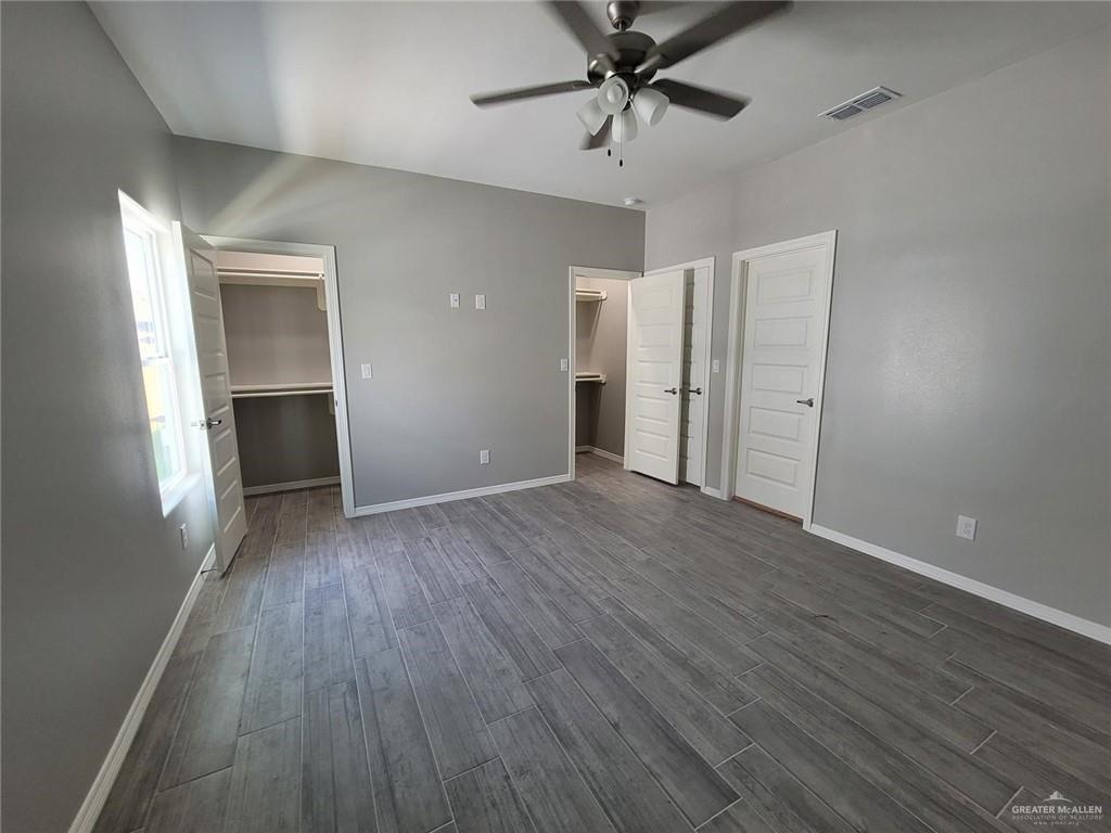 1913 Davenport Street, Unit 2 Weslaco, TX 78596 - Photo 4 of 13 wooden floor in an empty room with a window