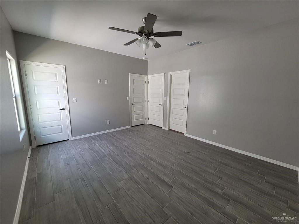 1913 Davenport Street, Unit 2 Weslaco, TX 78596 - Photo 5 of 13 an empty room with wooden floor and ceiling fan