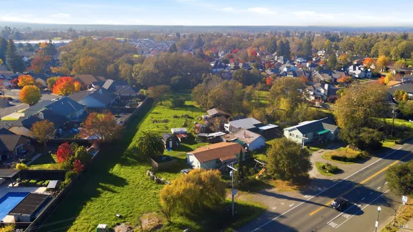 an aerial view of residential houses with outdoor space