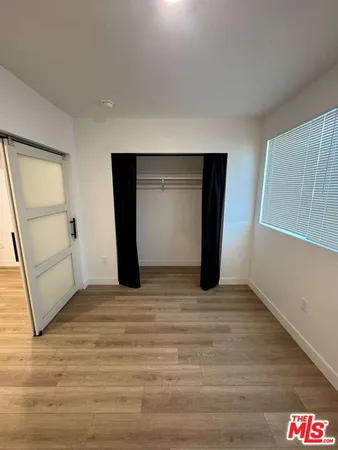 a view of a room with wooden floor