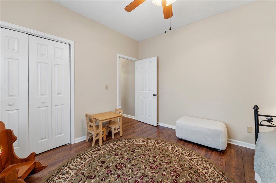 160 Wexford Drive, Unit 206 Anderson, SC 29621 - Photo 29 of 31 LVP floors and a ceiling fan create a comfortable atmosphere in this inviting bedroom.