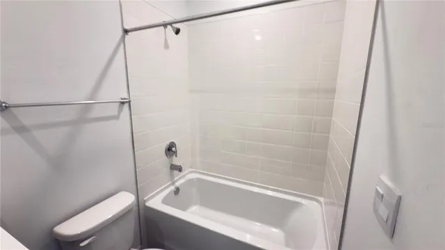 a white toilet sitting next to a bathroom sink