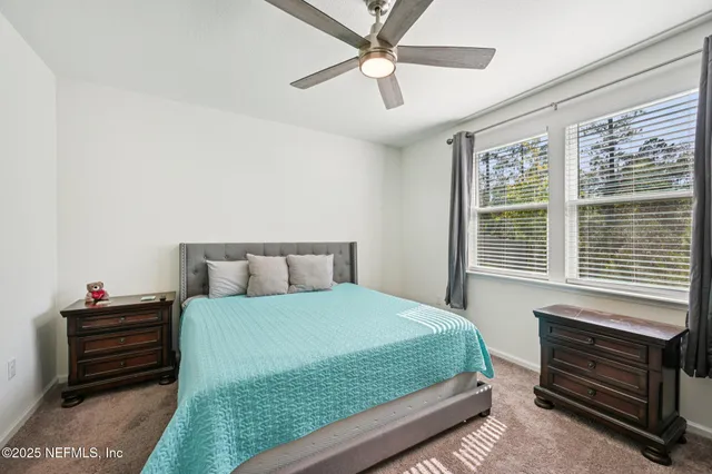 a bedroom with a bed dresser and a window