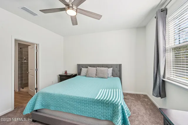 a bedroom with a bed and window