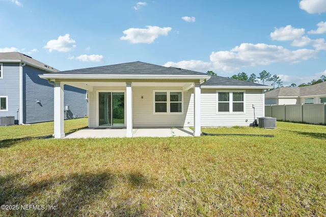 a view of an house with backyard space and balcony