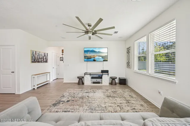 a living room with furniture and a large window