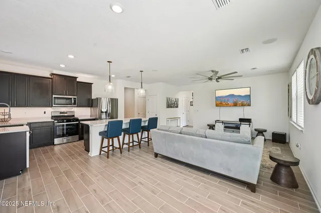 a living room with furniture and kitchen view