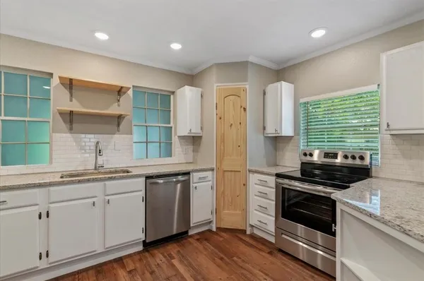 a kitchen with a sink stove and cabinets