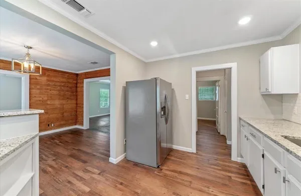 a kitchen with stainless steel appliances granite countertop a refrigerator and a sink