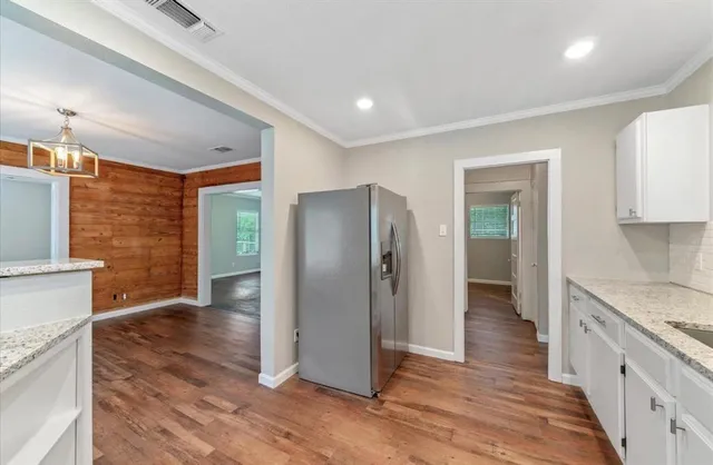a kitchen with stainless steel appliances granite countertop a refrigerator and a sink