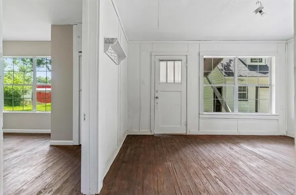a view of room with window and wooden floor