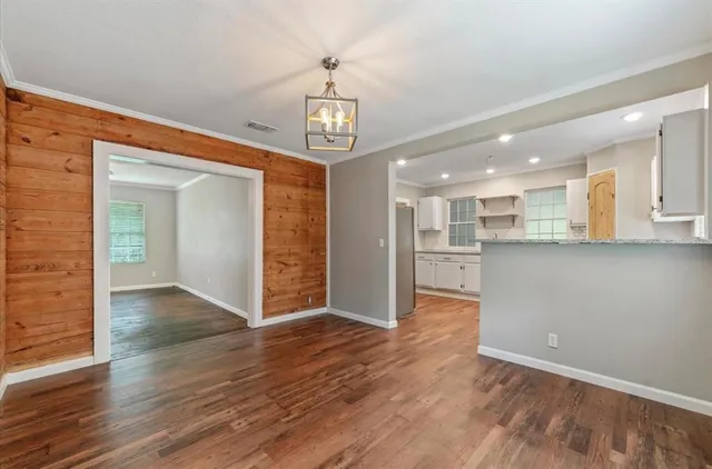a view of a kitchen with wooden floor and a kitchen