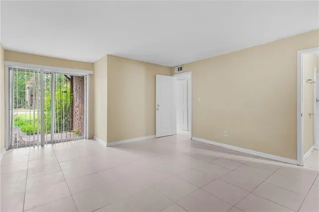 a view of an empty room with glass door